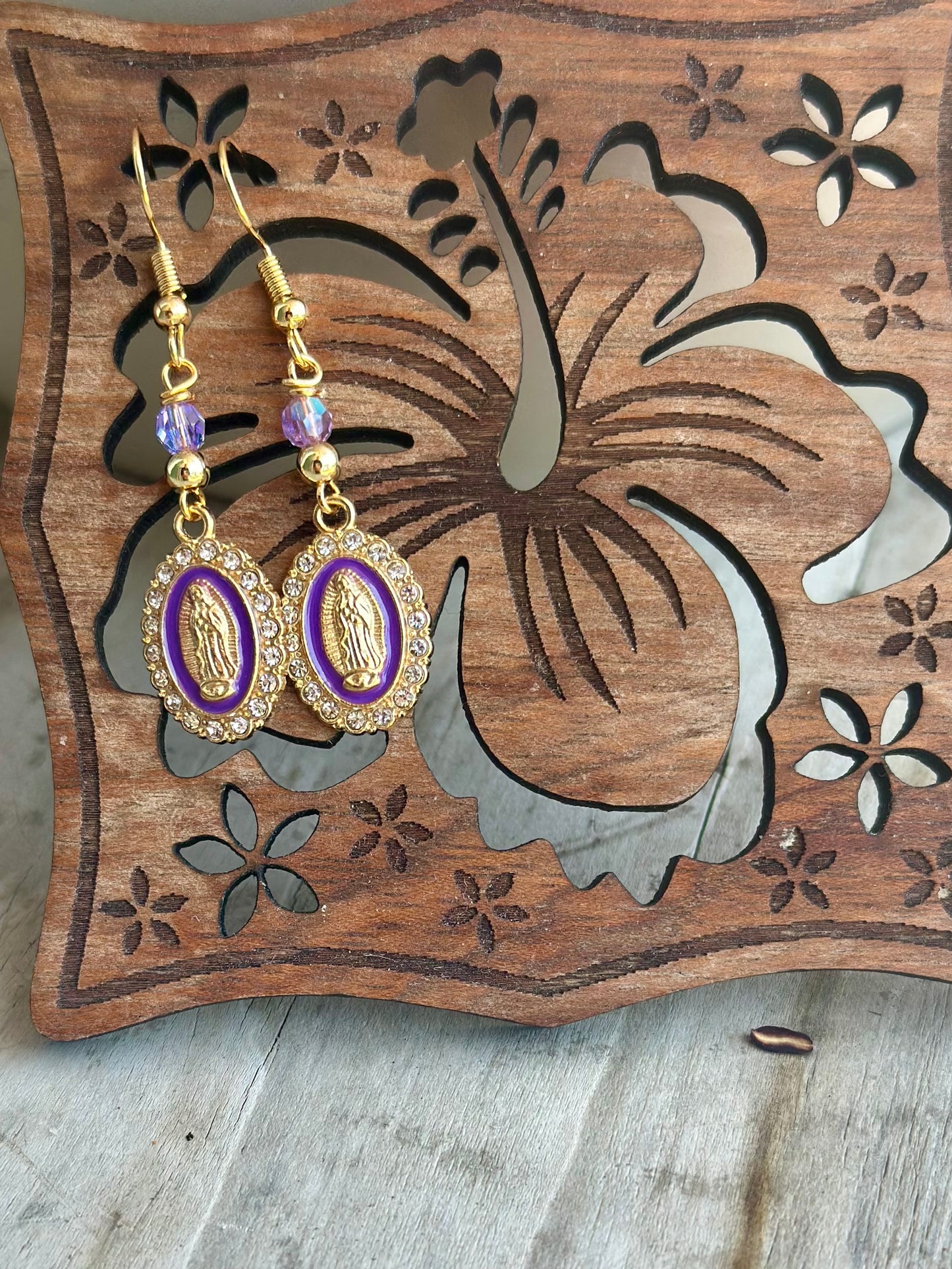 Dangle and Drop Virgen de Guadalupe Earrings in Gold and Purple.