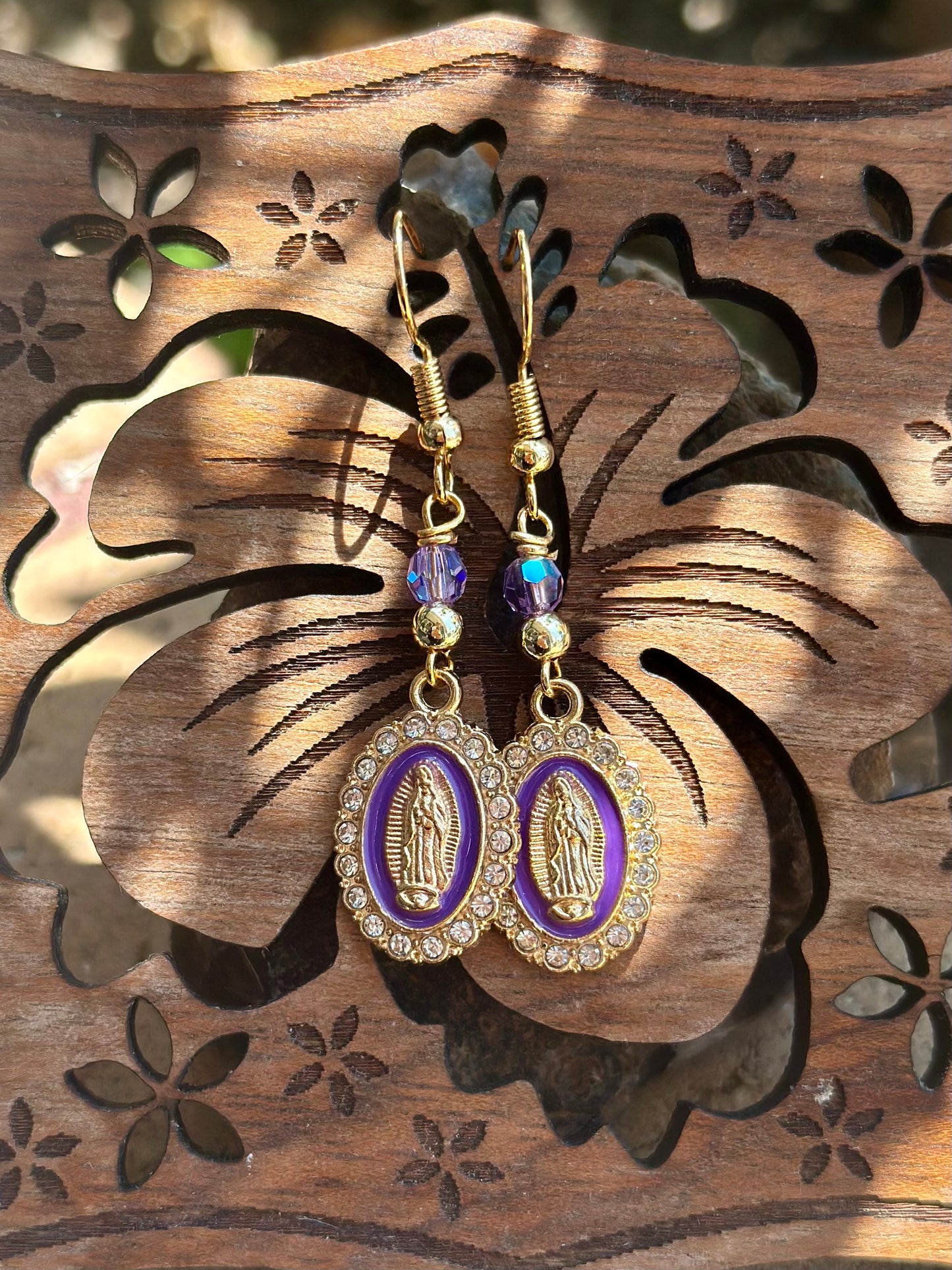 Dangle and Drop Virgen de Guadalupe Earrings in Gold and Purple.