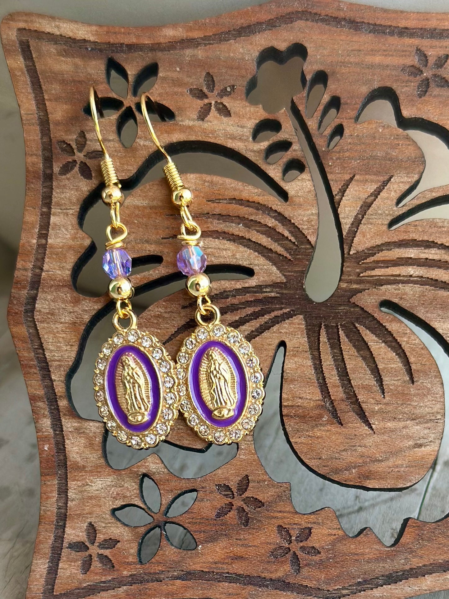 Dangle and Drop Virgen de Guadalupe Earrings in Gold and Purple.