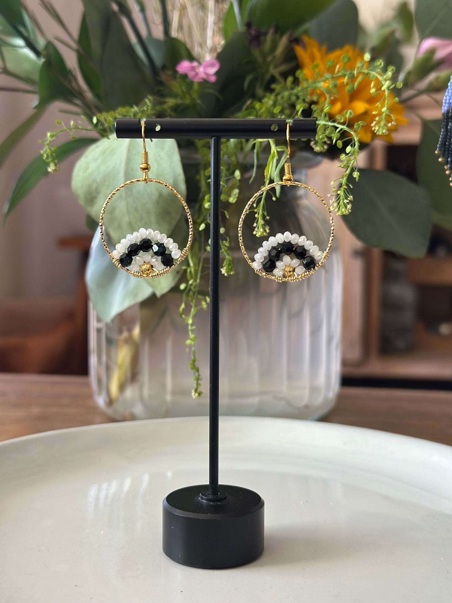 Dangle and Drop Earrings in White and Black, and Gold.