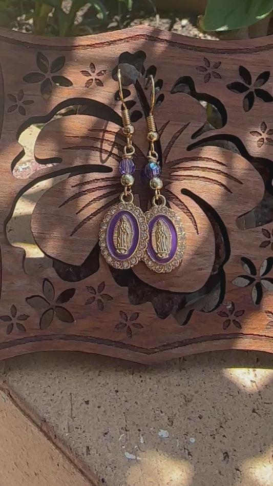 Dangle and Drop Virgen de Guadalupe Earrings in Gold and Purple.